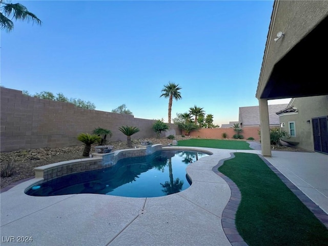 view of swimming pool with a fenced backyard, a fenced in pool, and a patio