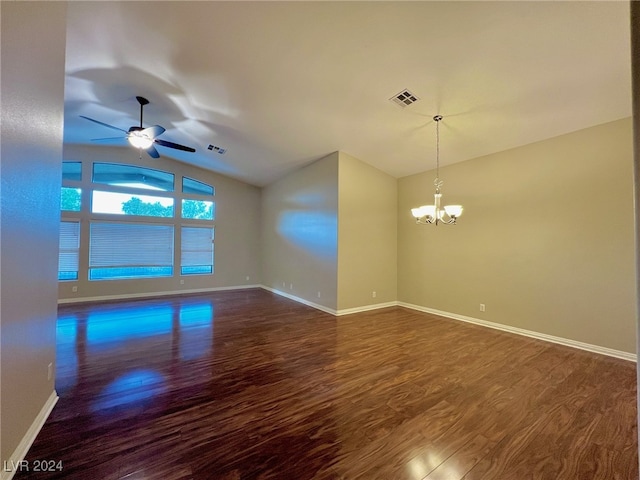 empty room with ceiling fan with notable chandelier, vaulted ceiling, and dark hardwood / wood-style flooring