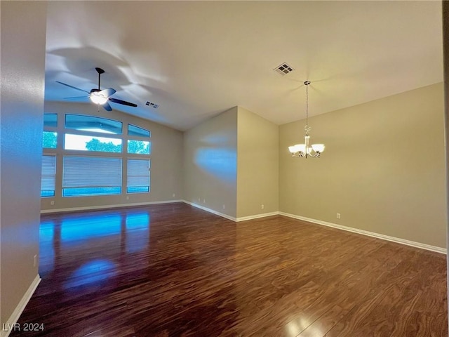 empty room with visible vents, baseboards, dark wood finished floors, ceiling fan with notable chandelier, and lofted ceiling