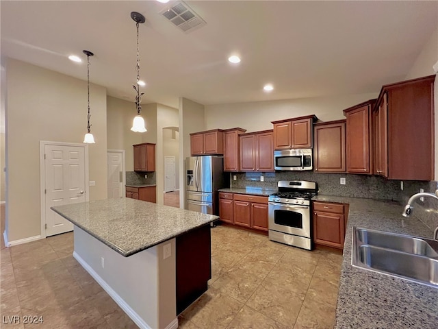 kitchen with backsplash, a center island, decorative light fixtures, stainless steel appliances, and sink