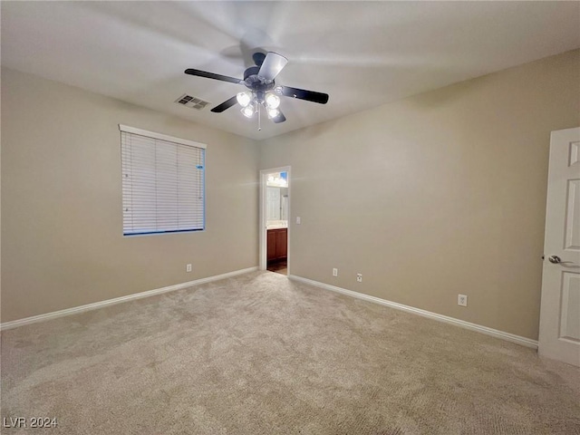 unfurnished bedroom with ceiling fan, ensuite bath, visible vents, carpet floors, and baseboards