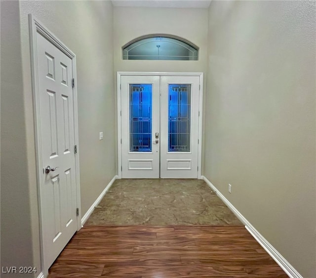 entryway with wood-type flooring and french doors