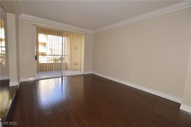 empty room featuring dark wood-type flooring and crown molding