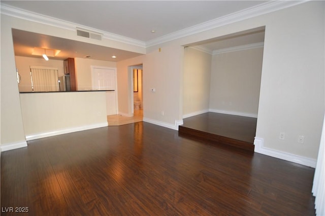 spare room featuring crown molding and dark hardwood / wood-style flooring