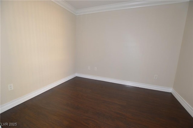 spare room featuring dark hardwood / wood-style floors and ornamental molding