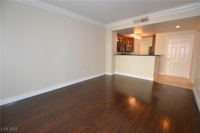 unfurnished living room featuring dark hardwood / wood-style floors and crown molding