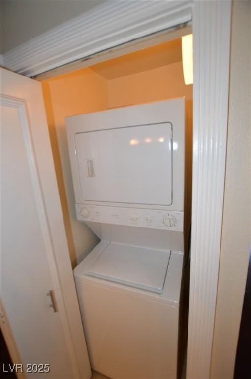 laundry area featuring stacked washer and clothes dryer