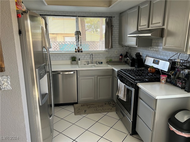 kitchen featuring gray cabinets, plenty of natural light, stainless steel appliances, and sink