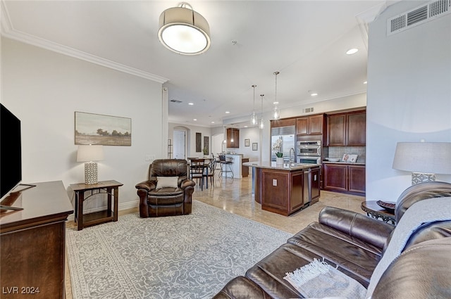 living room with ornamental molding and sink