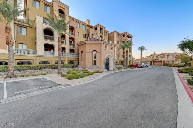 view of property with uncovered parking and a residential view