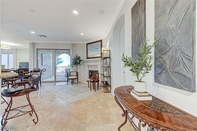 living room featuring recessed lighting, visible vents, arched walkways, crown molding, and a fireplace