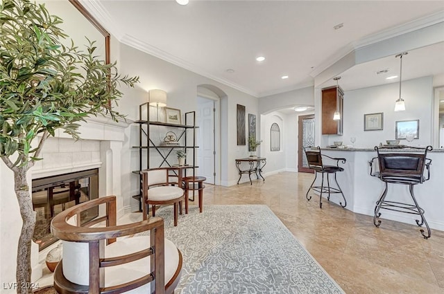 living room featuring arched walkways, crown molding, baseboards, and recessed lighting