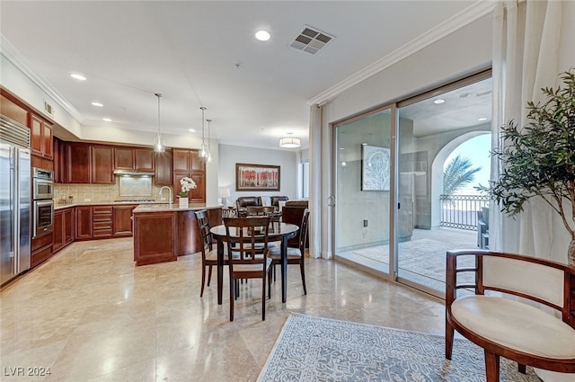 dining area featuring a wealth of natural light, ornamental molding, and sink