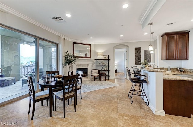 dining area featuring recessed lighting, ornamental molding, visible vents, and a fireplace