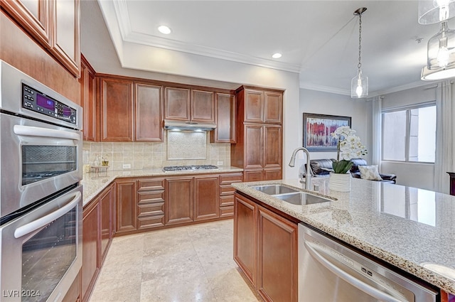 kitchen with light stone countertops, pendant lighting, crown molding, stainless steel appliances, and sink