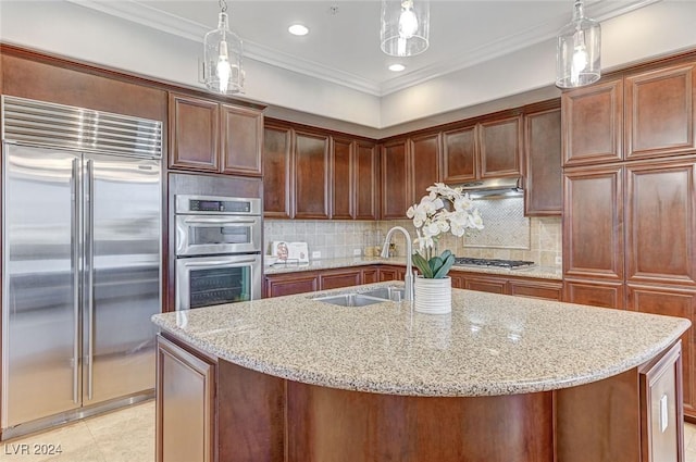 kitchen featuring under cabinet range hood, decorative backsplash, appliances with stainless steel finishes, and a sink