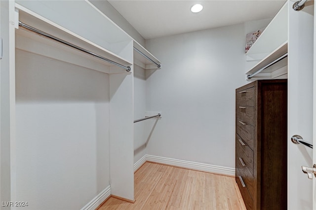 walk in closet featuring light hardwood / wood-style flooring