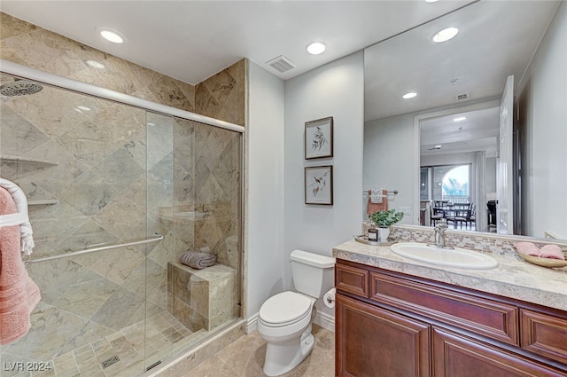 bathroom with vanity, toilet, and walk in shower