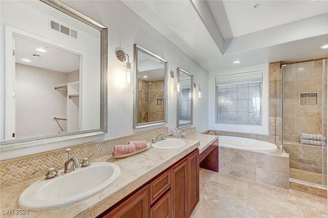 bathroom featuring backsplash, shower with separate bathtub, and vanity