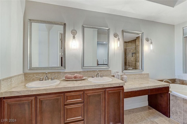 bathroom with double vanity, a bath, tiled shower, and a sink