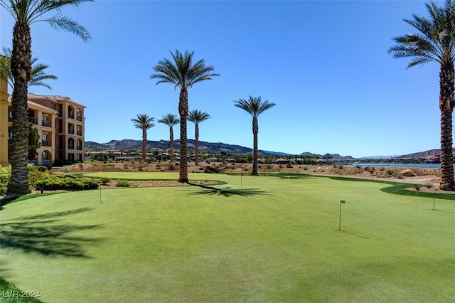 surrounding community with a water and mountain view