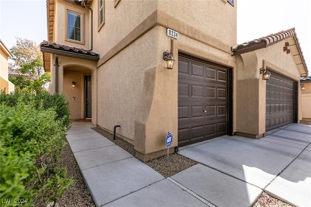 view of exterior entry with a garage