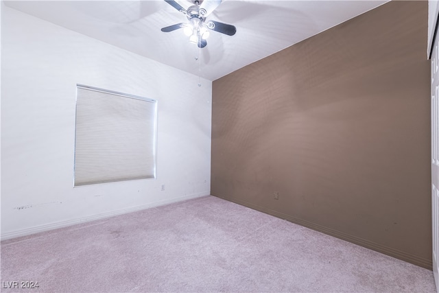 empty room with ceiling fan and light colored carpet