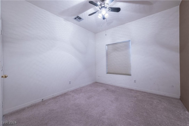 empty room with visible vents, baseboards, carpet, and ceiling fan