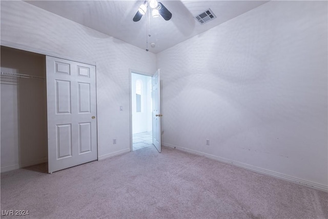 unfurnished bedroom featuring visible vents, a ceiling fan, a closet, carpet flooring, and baseboards