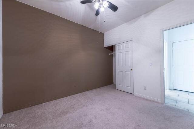 unfurnished bedroom with ceiling fan and light colored carpet