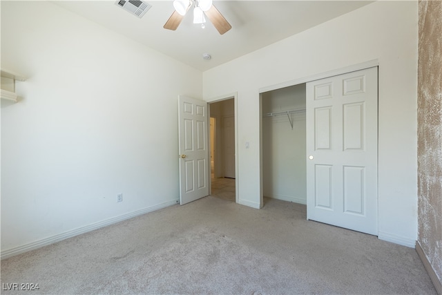 unfurnished bedroom with ceiling fan, light colored carpet, and a closet