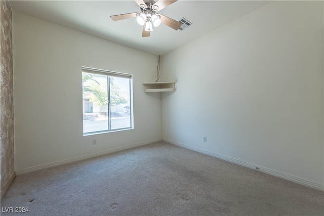 carpeted spare room featuring ceiling fan