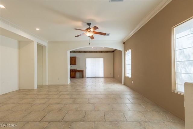 unfurnished room featuring ceiling fan and crown molding