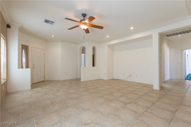 unfurnished room featuring ceiling fan and ornamental molding