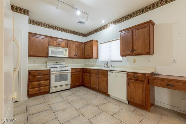 kitchen featuring white appliances and sink