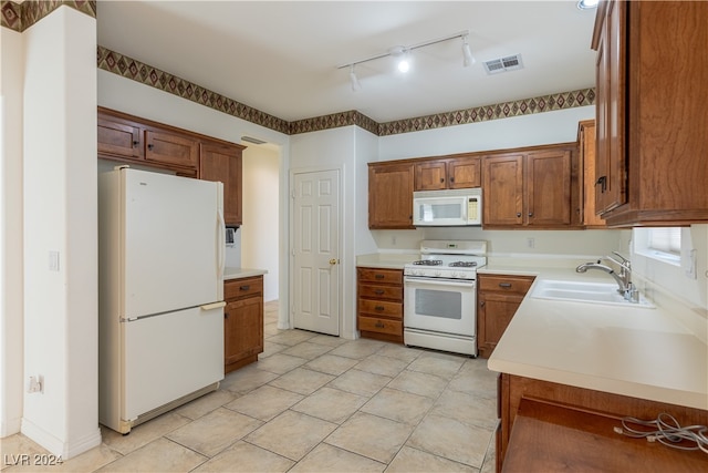 kitchen with sink and white appliances