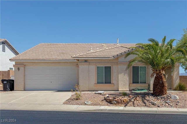 ranch-style house featuring stucco siding, an attached garage, and a tile roof