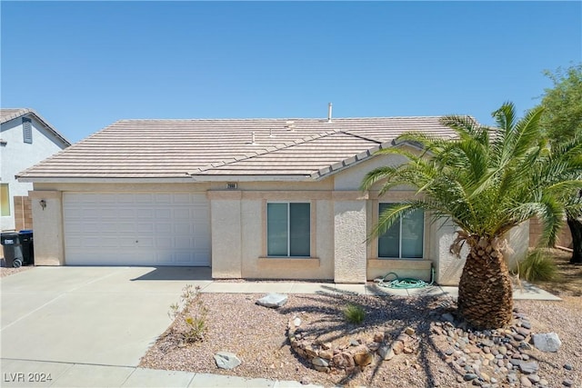 ranch-style house with a tile roof, an attached garage, concrete driveway, and stucco siding