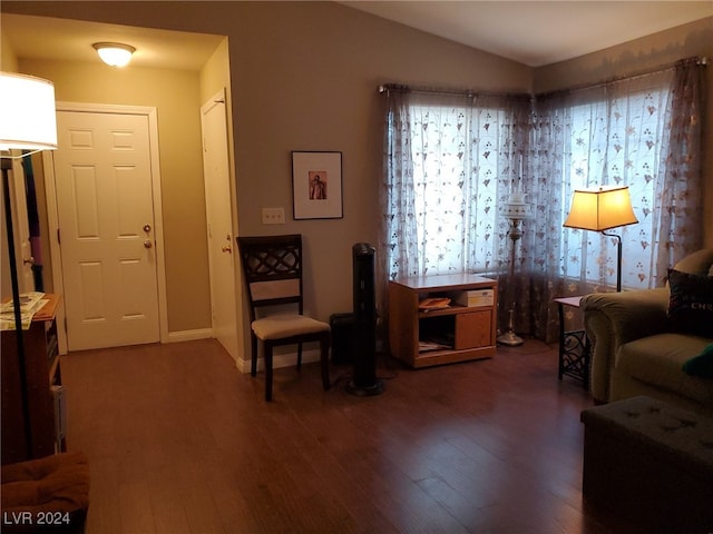 sitting room with lofted ceiling and dark hardwood / wood-style flooring