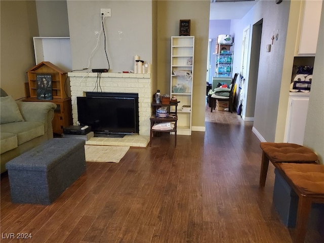 living room featuring hardwood / wood-style floors and a brick fireplace