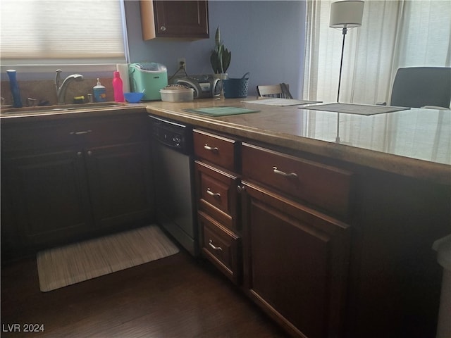 kitchen with black dishwasher, sink, dark brown cabinets, and dark hardwood / wood-style flooring