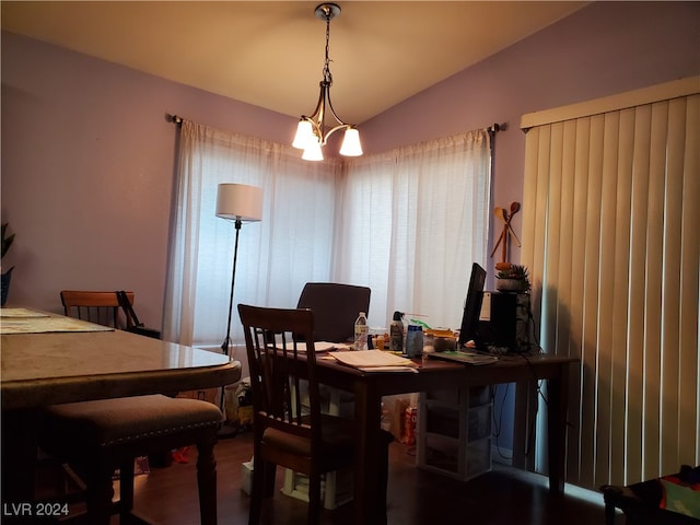 dining area with lofted ceiling and a notable chandelier