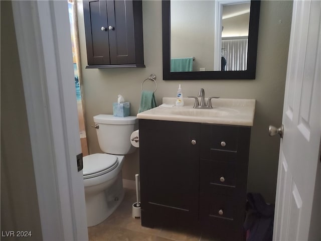 bathroom featuring toilet, vanity, and tile patterned floors