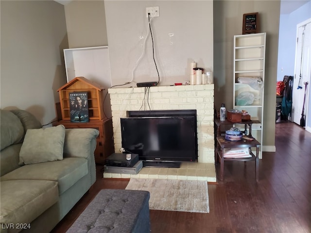 living room featuring hardwood / wood-style floors and a brick fireplace