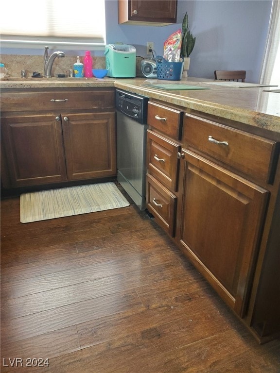 kitchen with sink, dishwasher, dark brown cabinets, and dark hardwood / wood-style floors