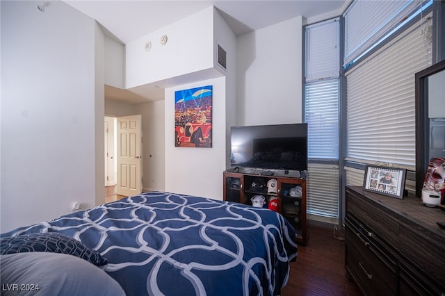 bedroom with dark hardwood / wood-style flooring