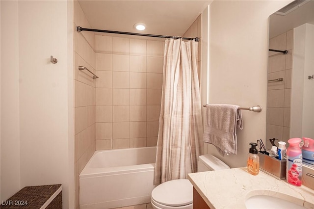 full bath featuring toilet, vanity, and shower / tub combo with curtain