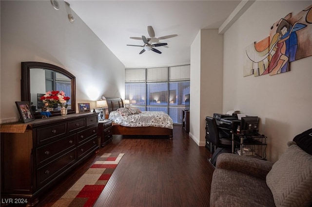 bedroom with dark wood-type flooring, ceiling fan, and a desk