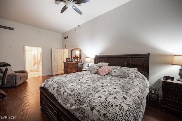 bedroom featuring vaulted ceiling, wood finished floors, a ceiling fan, and ensuite bath