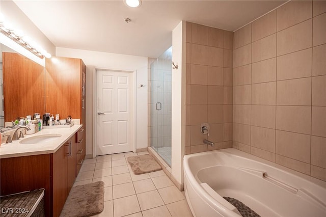 full bathroom featuring tile patterned flooring, a shower stall, a bath, and vanity